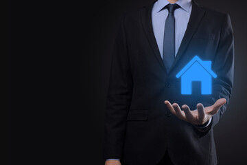 Real estate concept, businessman holding a house icon.House on Hand.Property insurance and security...