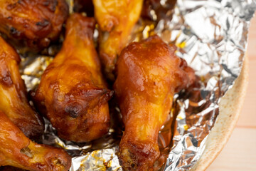 Shot of drumette chicken wing stick grilled on aluminium foil