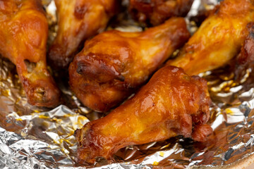 Shot of drumette chicken wing stick grilled on aluminium foil