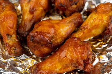 Shot of drumette chicken wing stick grilled on aluminium foil