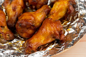 Shot of drumette chicken wing stick grilled on aluminium foil