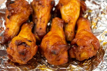 Shot of drumette chicken wing stick grilled on aluminium foil