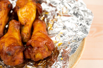 Shot of drumette chicken wing stick grilled on aluminium foil