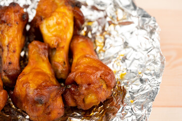 Shot of drumette chicken wing stick grilled on aluminium foil