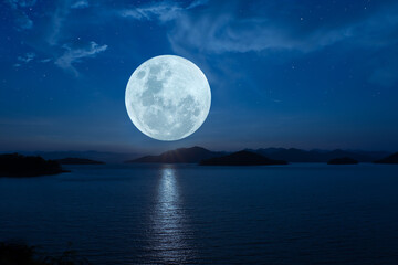 Naklejka na ściany i meble Full moon over lake in the dark night.