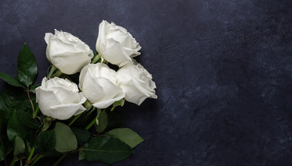 White rose flowers bouquet on black stone background. Greeting card with copy space for text