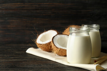 Fresh coconut and coconut milk on wooden background