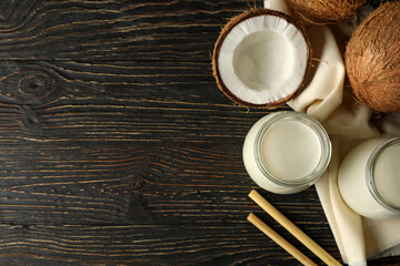 Fresh coconut and coconut milk on wooden background