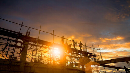 Silhouette Engineer and construction team working at site over blurred  industry background with...
