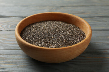 Bowl with chia seeds on wooden background