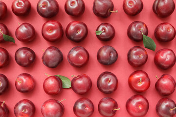 Fresh ripe plums on  color background