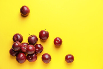 Fresh ripe plums on  color background