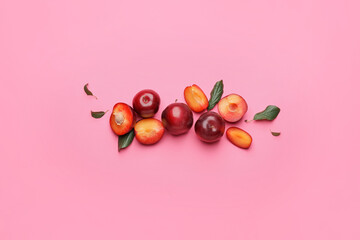 Fresh ripe plums on  color background