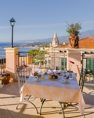 Taormina Sicily Italy breakfast table with a rooftop view over Taormina breakfast with coffee bread...