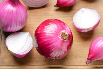 Fresh raw onion on wooden background