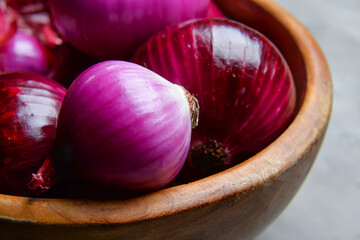 Fresh raw onion in bowl, closeup