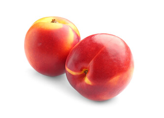 Two sweet ripe peaches on white background