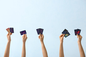 Female hands with credit cards on light background