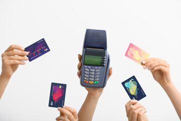 Female hands with credit cards and payment terminal on white background