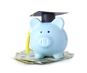 Piggy bank with graduation hat and money on white background. Tuition fees concept