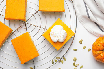 Pieces of tasty pumpkin pie on white background