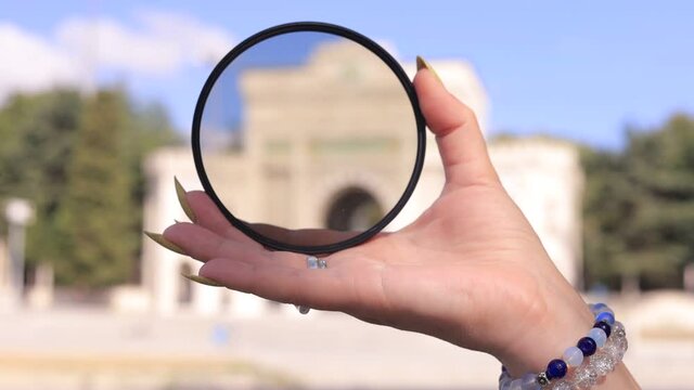 Female hand holding a large diameter photo filter