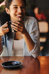Woman with a cup of coffee sitting at cafe