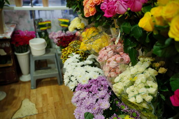 Bouquets of various flowers on counter. Fresh beautiful flowers in florist shop.