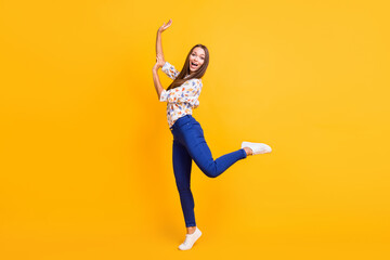 Full length photo portrait of funny woman dancing standing on one leg like ballerina isolated on vivid yellow colored background