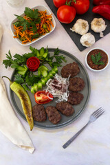 Fototapeta na wymiar Delicious Turkish traditional kebab meatballs on white background. Turkish Food Kofte or Kofta (meatball).