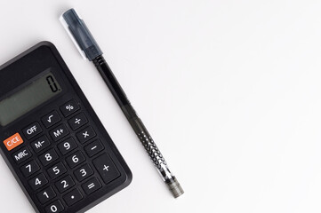 calculator with a pen on a white background. Counting on the calculator