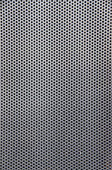 Perforated metal mesh as a texture or background in portrait format. High quality photo