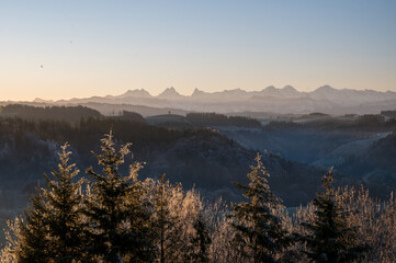 hills of Emmental with Bernese Alps as a backdrop on a frosty morning