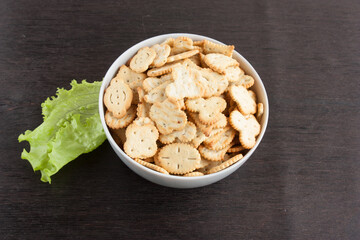 delicious dry cookies, biscuits, crackers with salt and herbs in a clay bowl