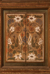 Beautiful, handmade decoration. White flowers painted on wood. Ancient interior design from the Orient. 
