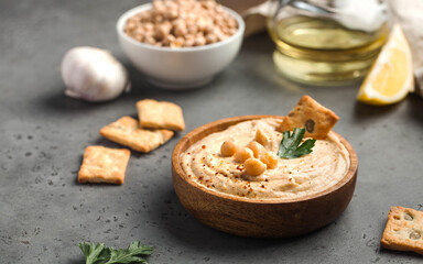 Hummus in a wooden plate with parsley and croutons. Dishes of chickpeas, a vegetarian dish.