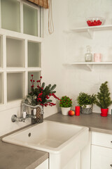 New Year's decor of modern kitchen in Scandinavian style. White light rustic kitchen close-up and copy space. Hygge kitchen details New year concept. Selective focus