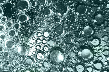 abstract tidewater green background with oil circles . water drops close up . oil bubbles in the water macro.