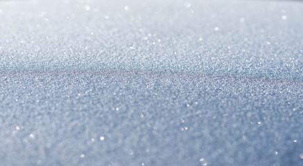 Surface covered with frost, natural winter texture and banner background, macro photography with sparkles and bokeh, shallow depth of field