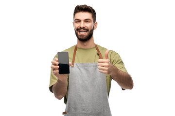 people, technology and job concept - happy smiling barman in apron showing smartphone and thumbs up gesture over white background