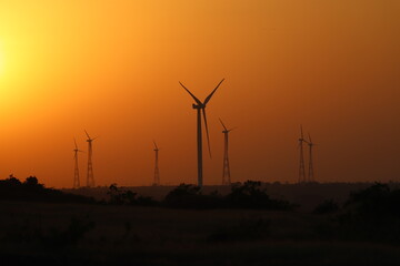 wind turbines at sunset