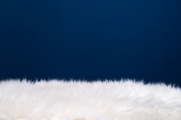 Texture of fluffy fur on blue background.