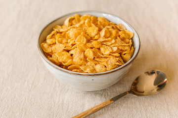 Cornflakes on a bowl on rustic background. Top view.	