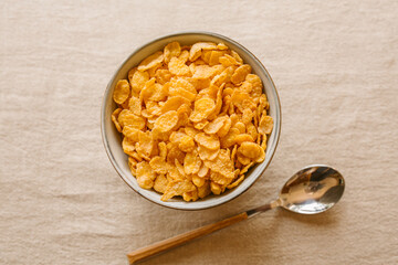Cornflakes on a bowl on rustic background. Top view.	