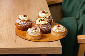 sweet dessert eclair shu with custard with pomegranate syrup and tartlet with white whipped cream...