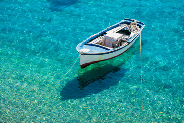 A fishing boat on the sea and Its shadow seen at the bottom easily in Kokkari village.