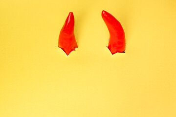 Bull horns from red peppers as symbol of new year 2021 on yellow background
