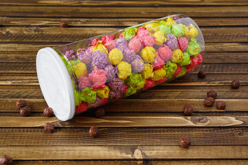 jar of colored popcorn on a woody vintage background. High quality photo