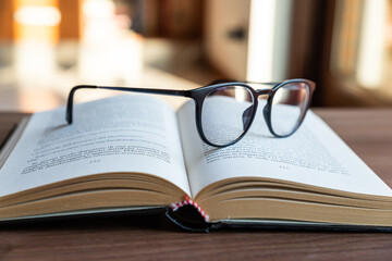 Open book, with eyeglasses on top