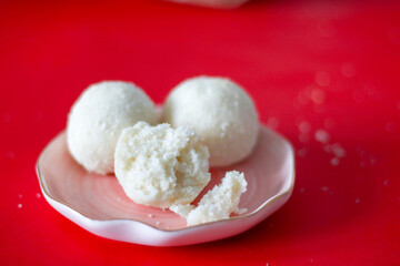 white coconut cookie balls on red background